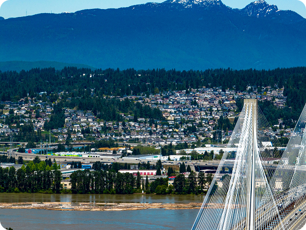 drone-shot-coquitlam-cityscape-with-port-mann-bridge-river-mountain-background