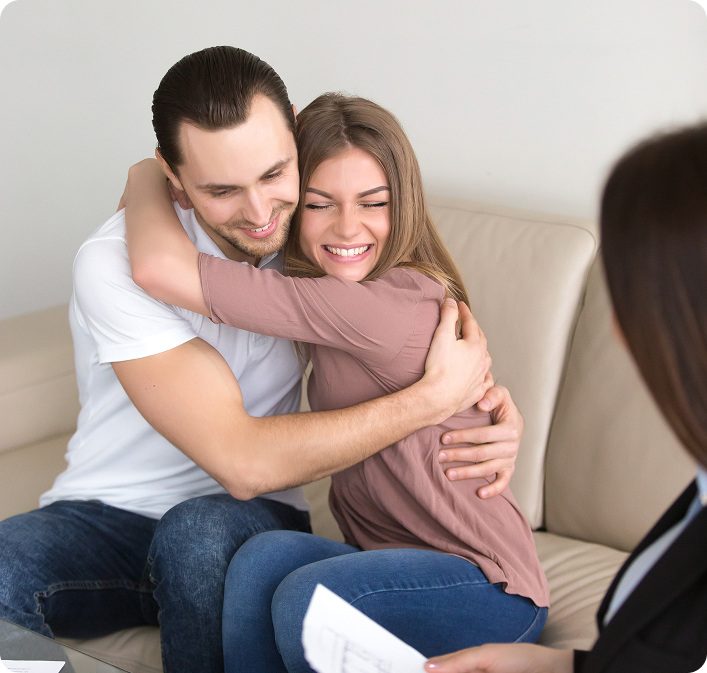 excited-couple-hugging-meeting-with-estate-agent-mortgage-investment